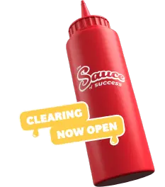 A sauce bottle with lots of stickers saying 'Clearing open'
