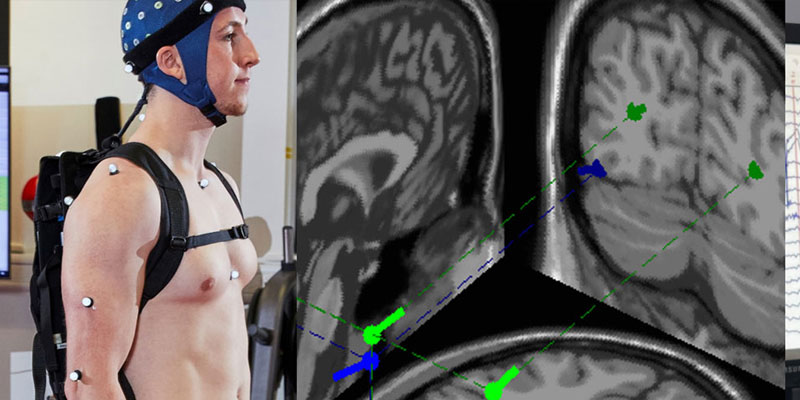 A person wearing sensors stood in front of an image of a brain