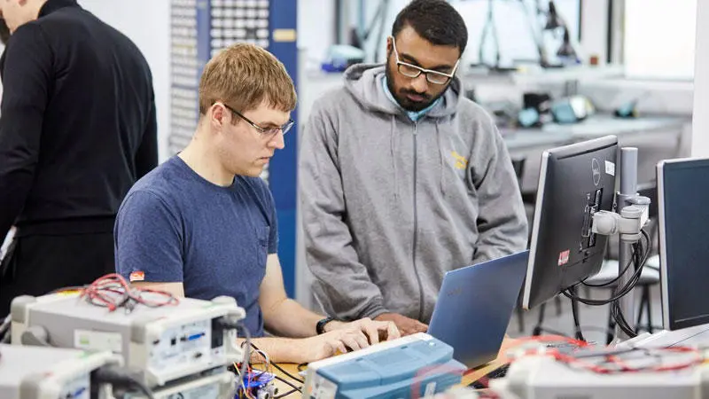 Two electronic engineering students in the electrical engineering lab