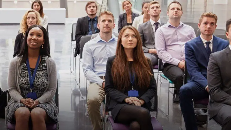 Group of conference attendees watching a presentation