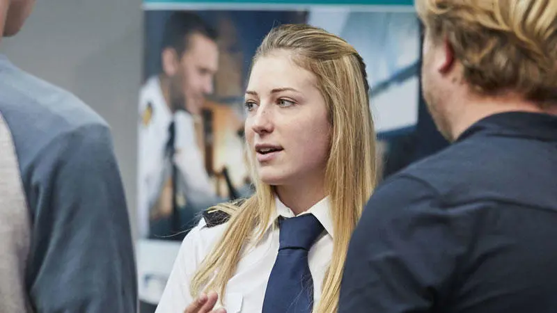 A female officer cadet talking to open day attendees