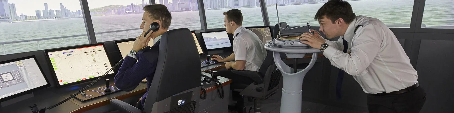 Three deck cadets in the bridge simulator