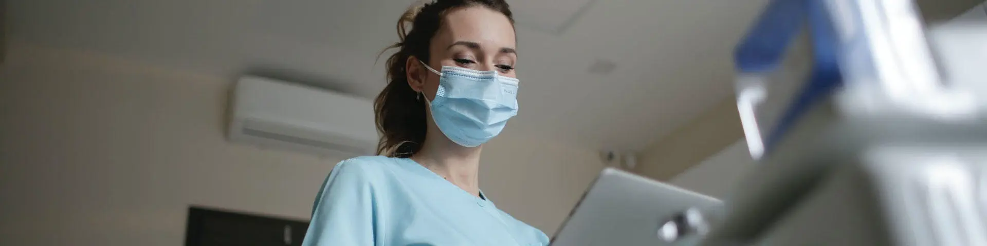 A nurse with a mask covering their face