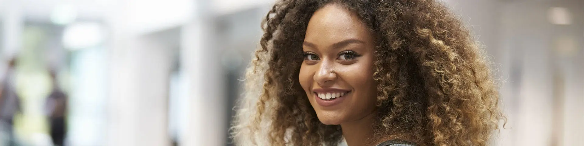 A female student smiling directly at the camera