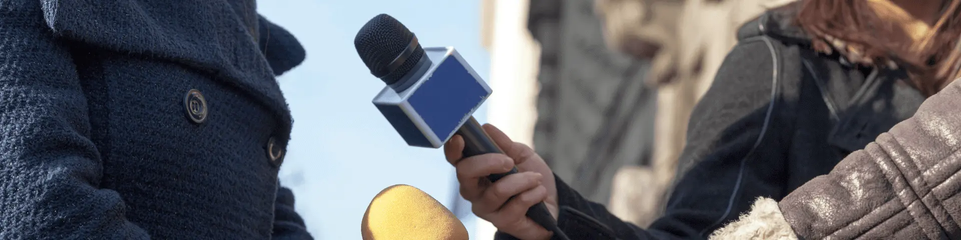 Interviewers holding microphones