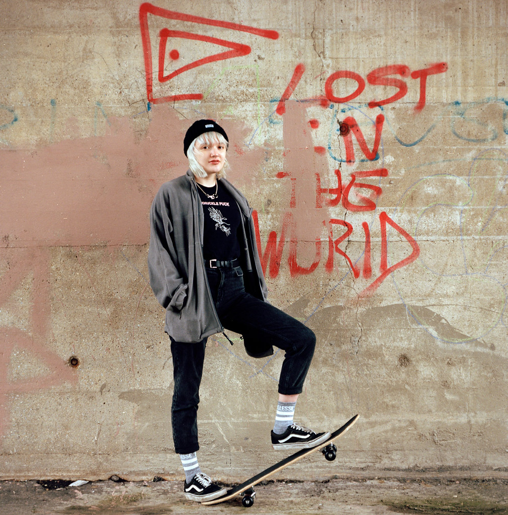 girl posing with skateboard