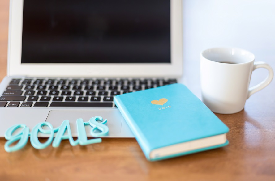 image of laptop and notebook next the the word 'goals'