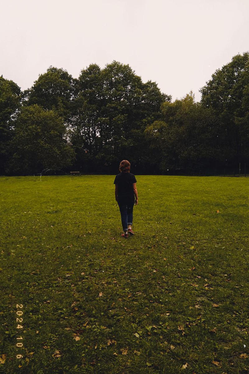 Abigail in a field walking away