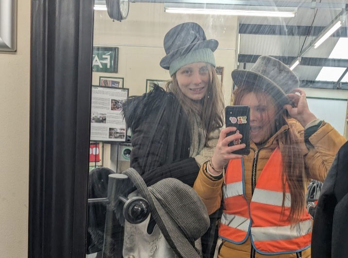 Bethany and a friend trying on costumes at the Watercress Line station