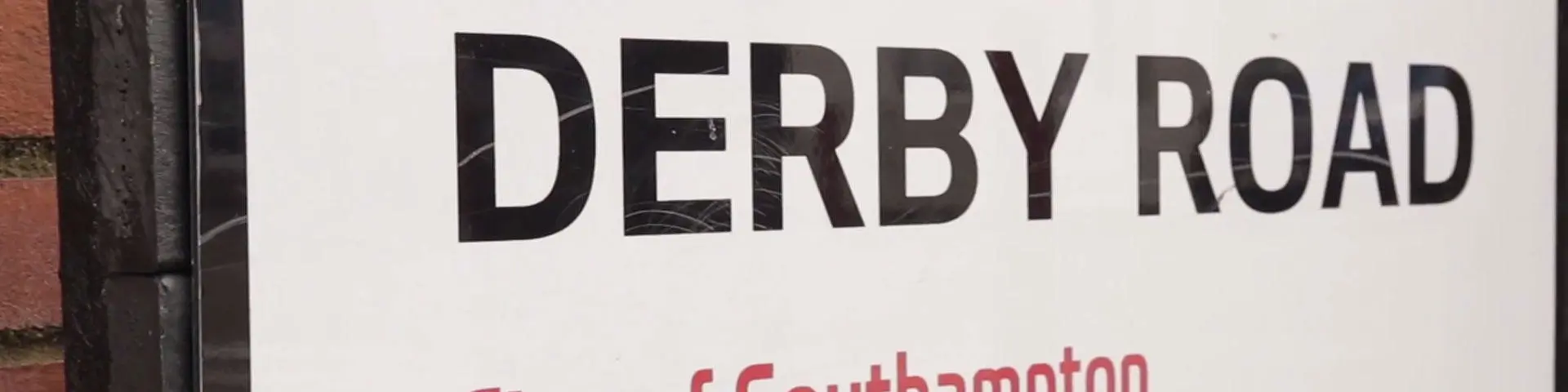 Street sign saying 'Derby Road'