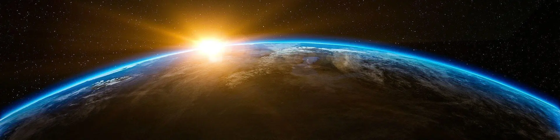 The sun rising over the globe, as seen from space