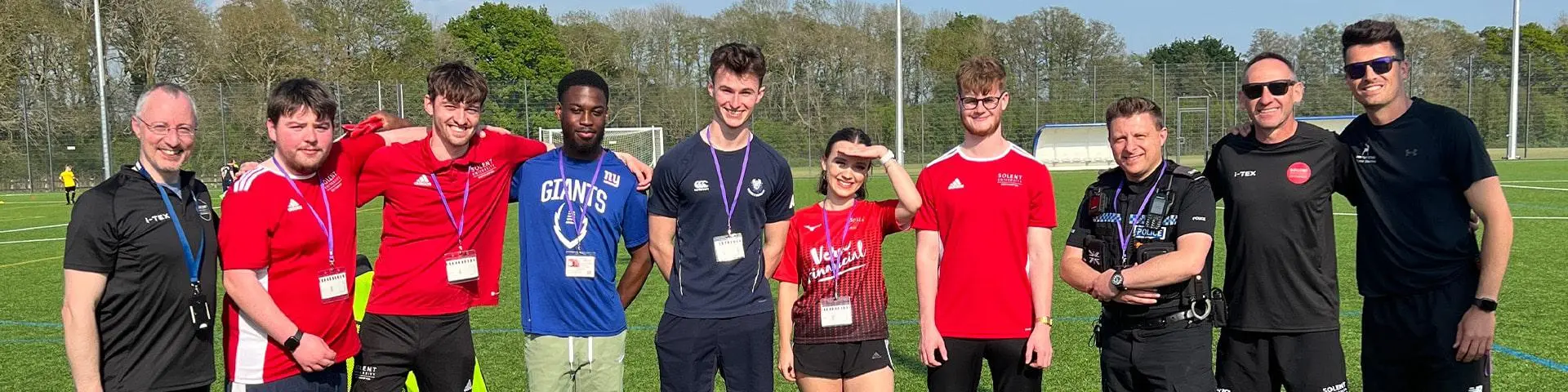 Staff and students together on a grass pitch at Deer Park Secondary School.