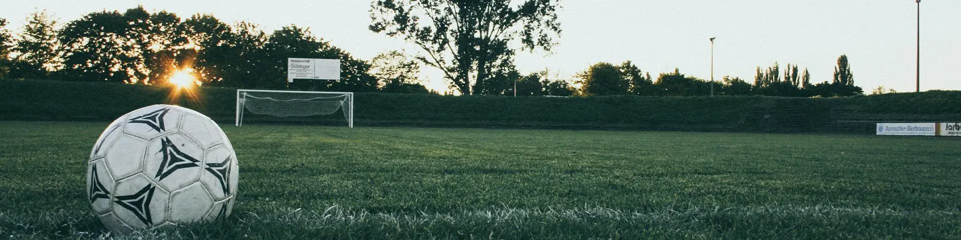 A football pitch at sunset.