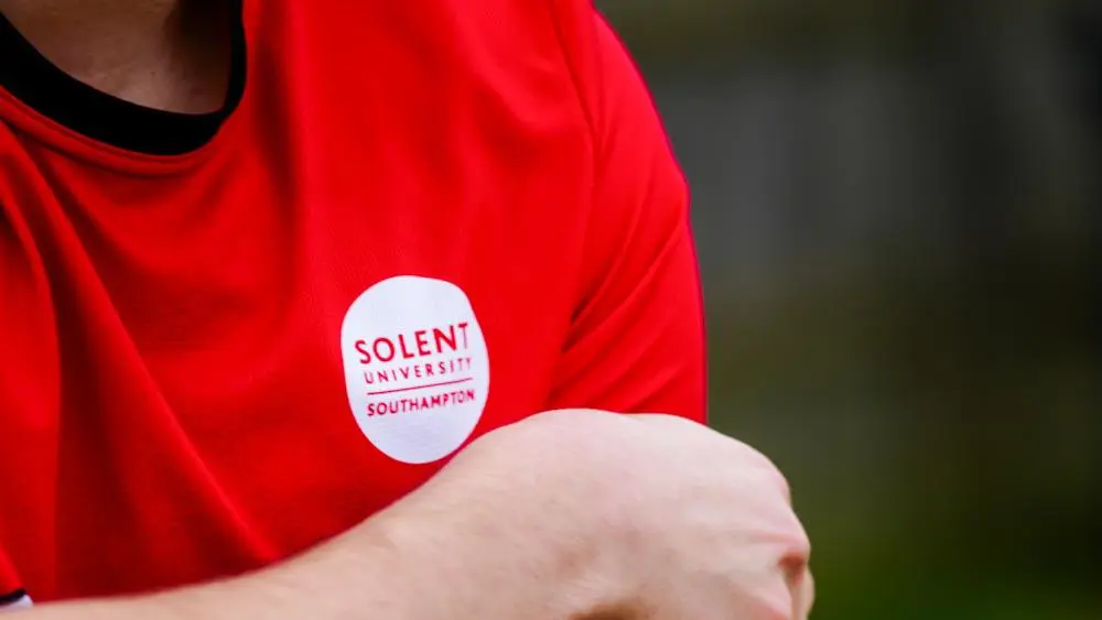Solent Men's Football captain adjusts his captain's armband