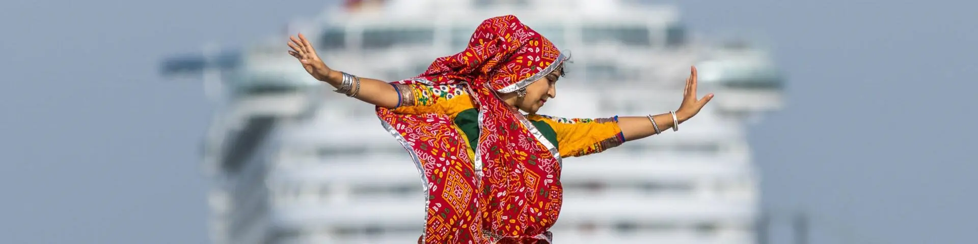 woman dancing in front of a ship