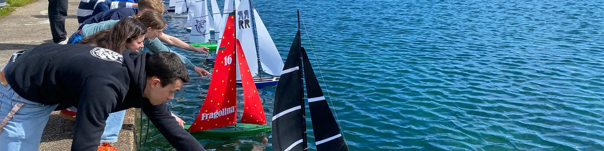 Yacht Design students launching their model yachts at Gosport Boating Lake.