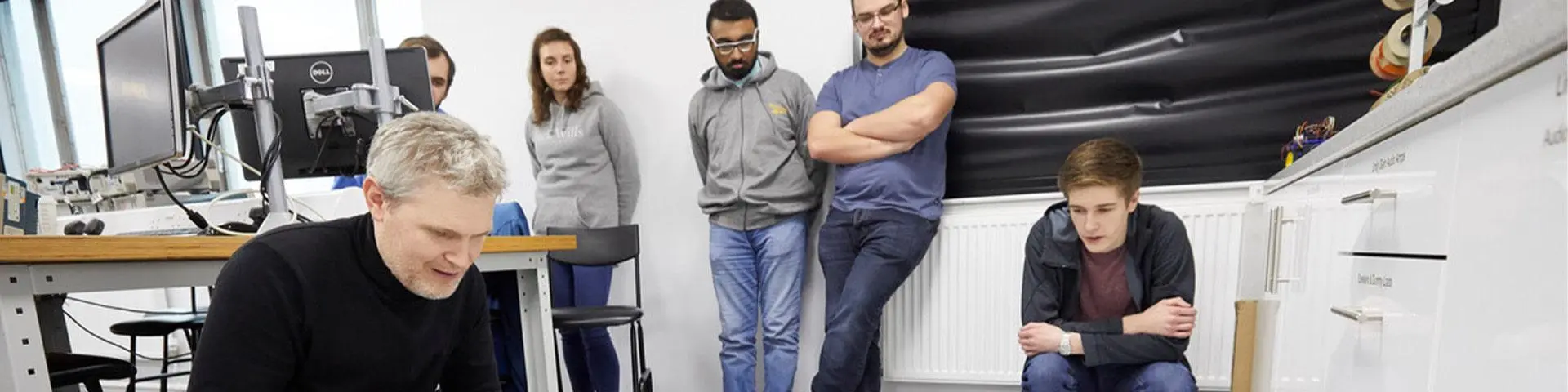 Students with a lecturer in a classroom.