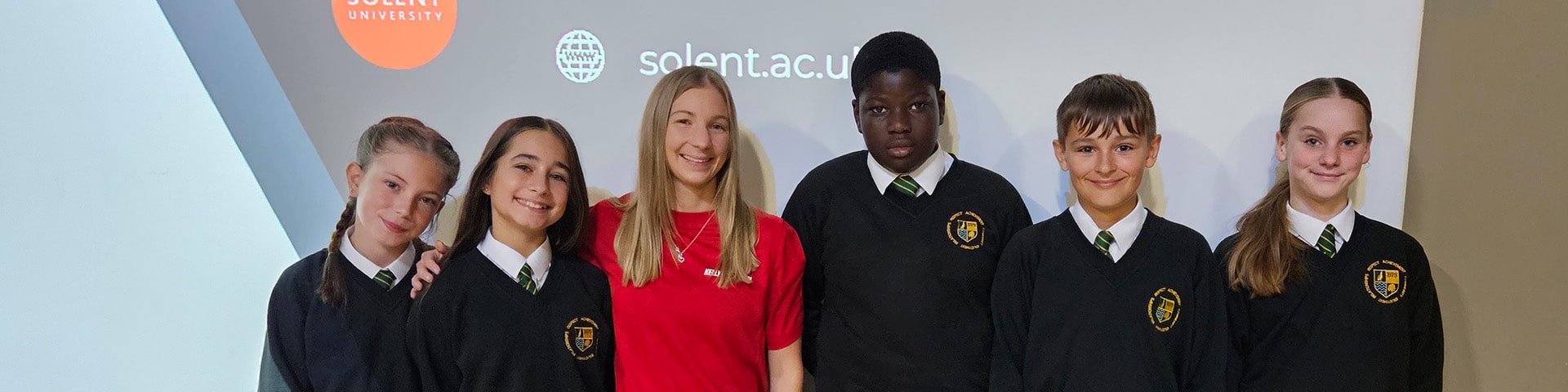 Gymnast Kelly Simm stands with secondary school pupils
