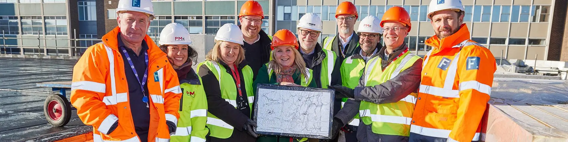 Representatives from Department of Education, South Coast IoT, Solent University, PMC and Francis Construction on the roof of the new facility