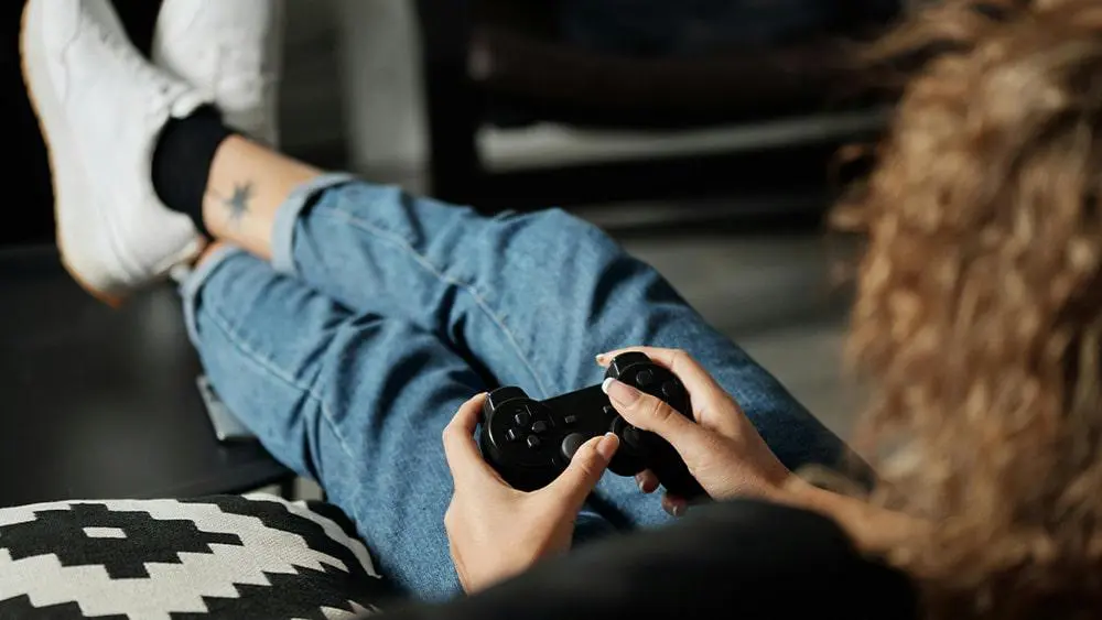 A woman playing a PlayStation