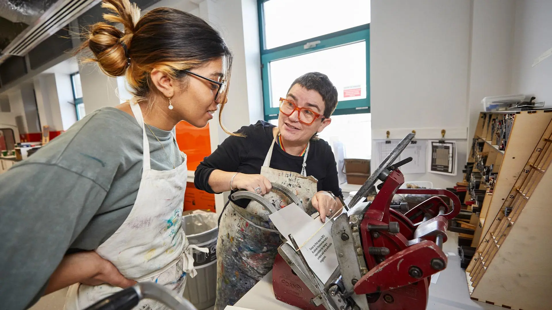 Student workign with lecturer in print room