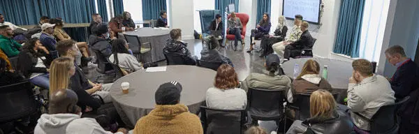 Students and speakers sat at tables attending a conference