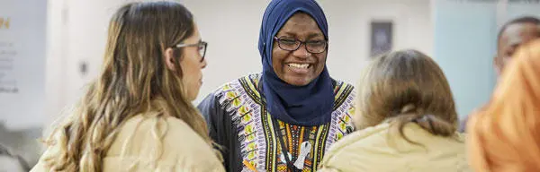 An employer smiling and talking to students