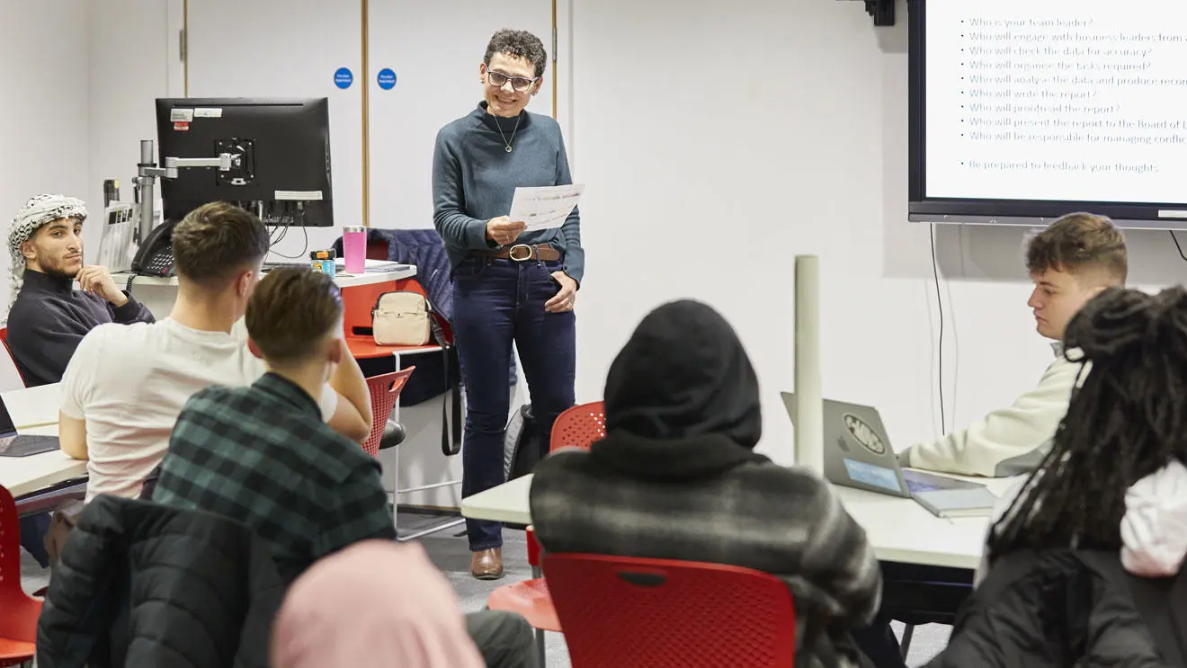 A business lecturer presenting to students