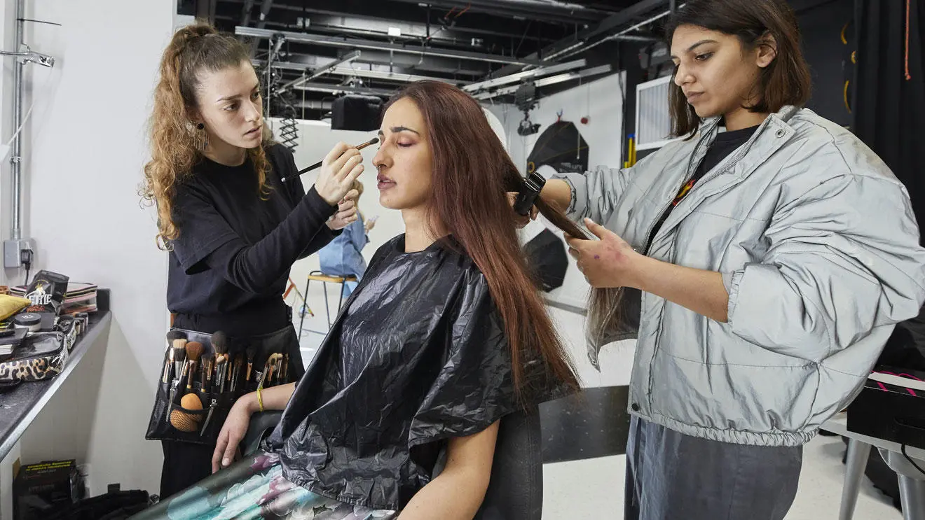 Make-up students working on a model