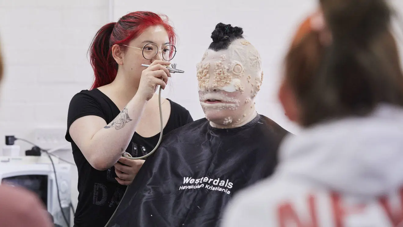 Prosthetics students working on a model