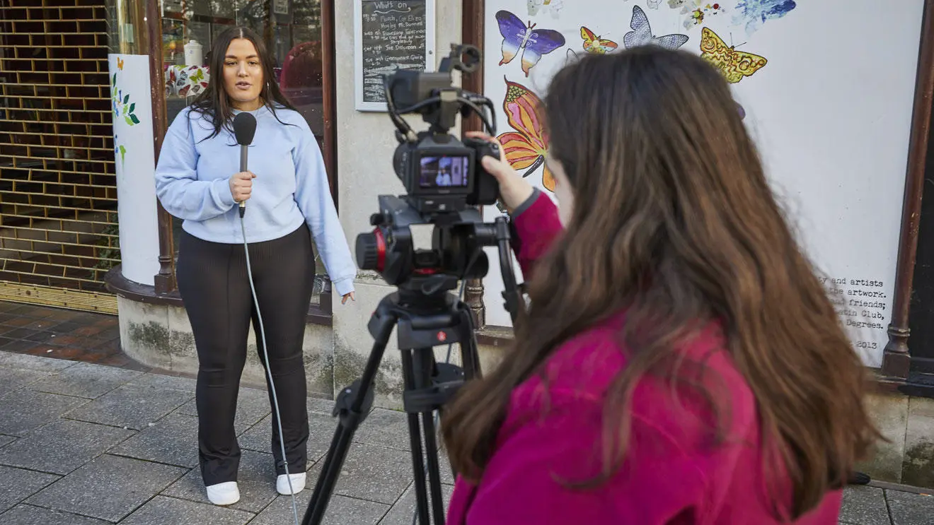 Two students filming