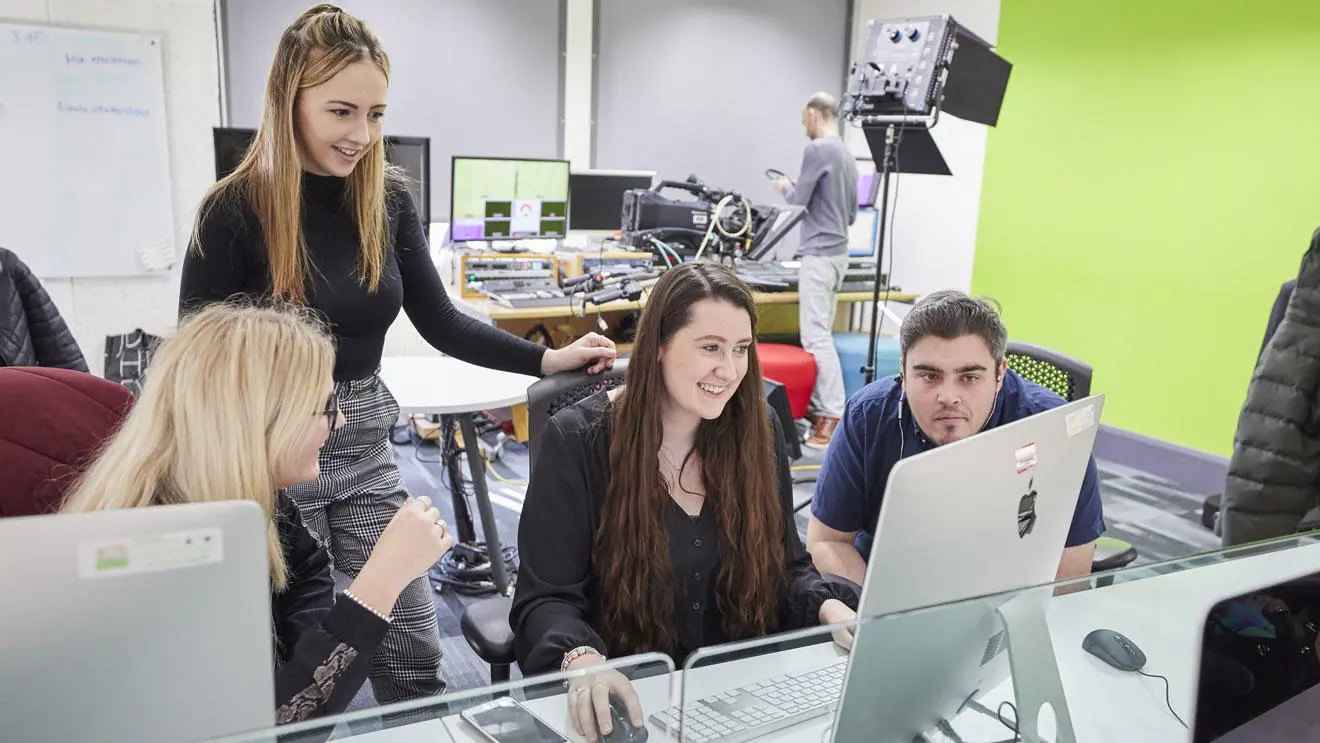 Media students in the journalism newsroom