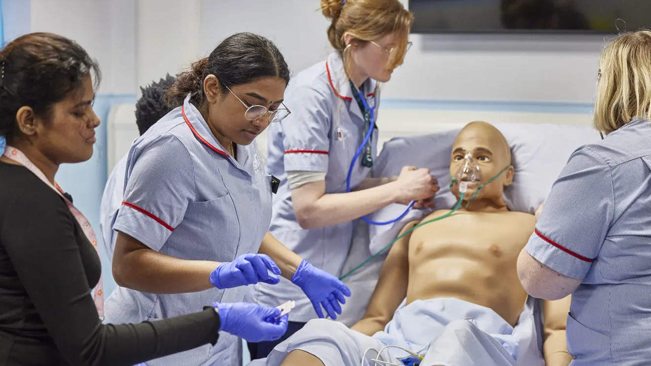 Nursing students with a 'patient' in the simulation ward