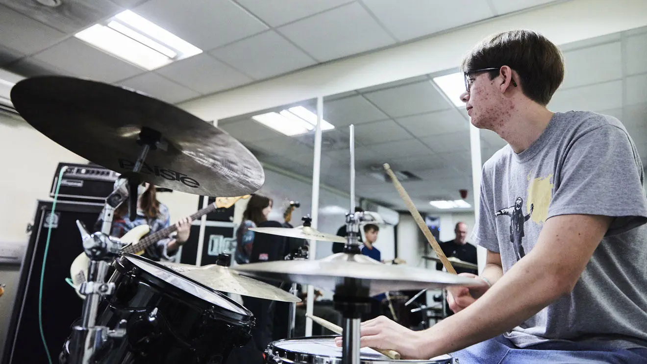 A music performance student on the drums