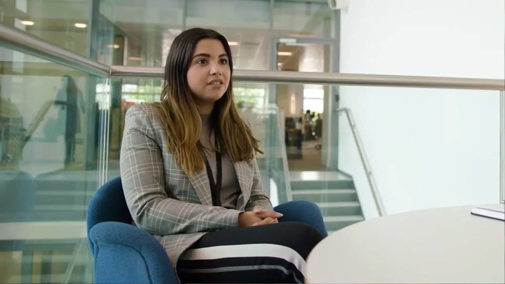 A person sat down and talking to the camera