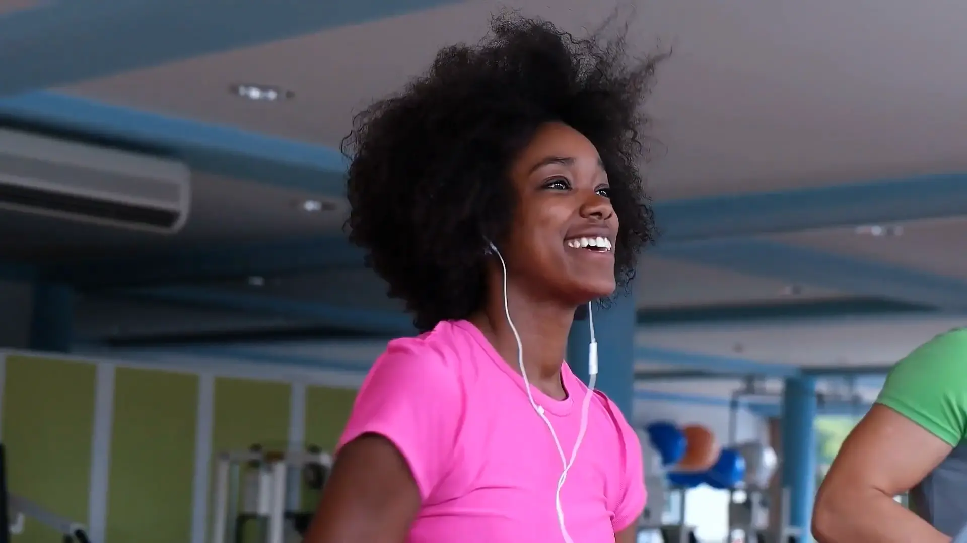 lady running at the gym with headphones in