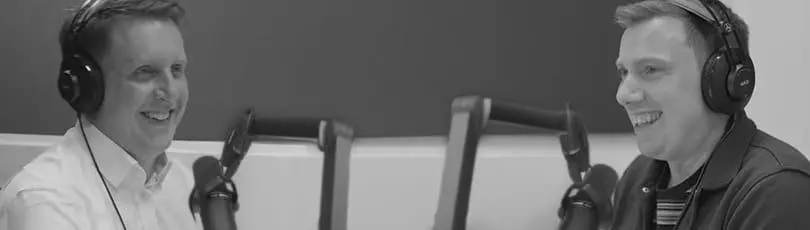 Solent lecturers wearing headphones and talking into a microphone