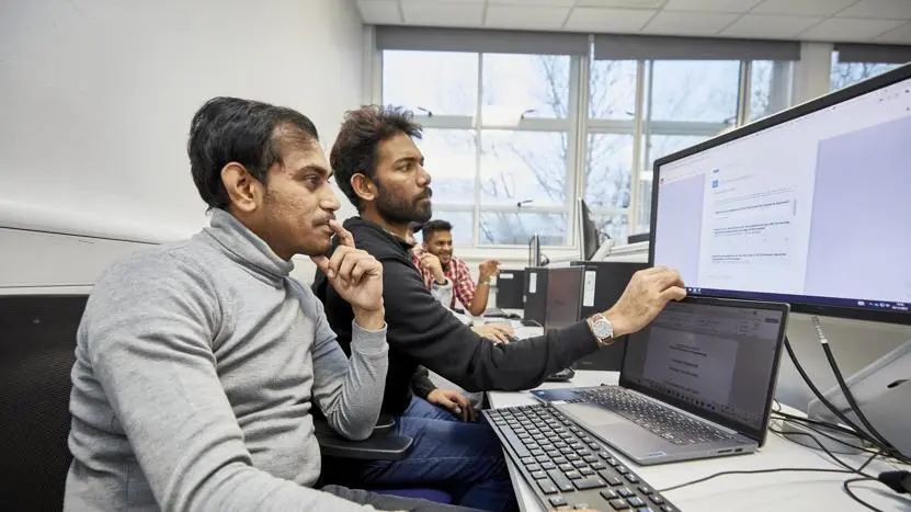 Two people working at a computer