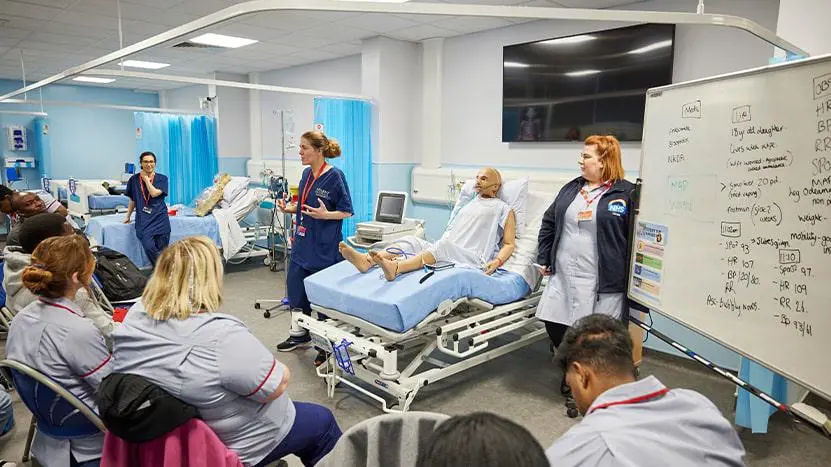 Health professionals working in a nursing simulation suite