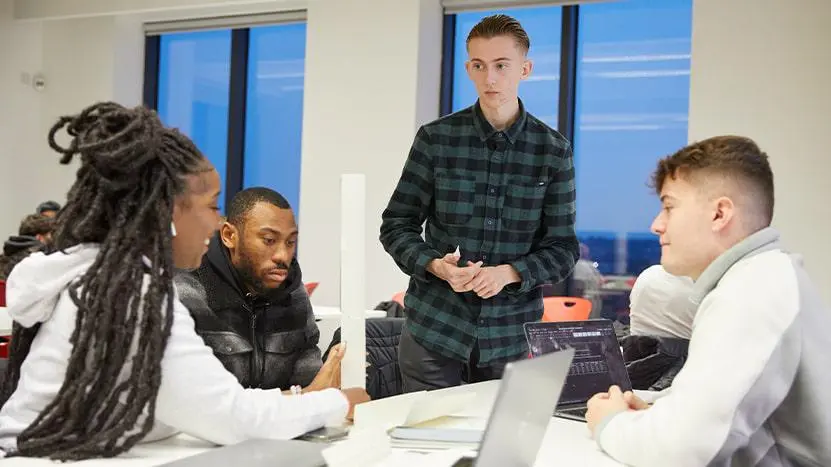 Image of people working around a desk