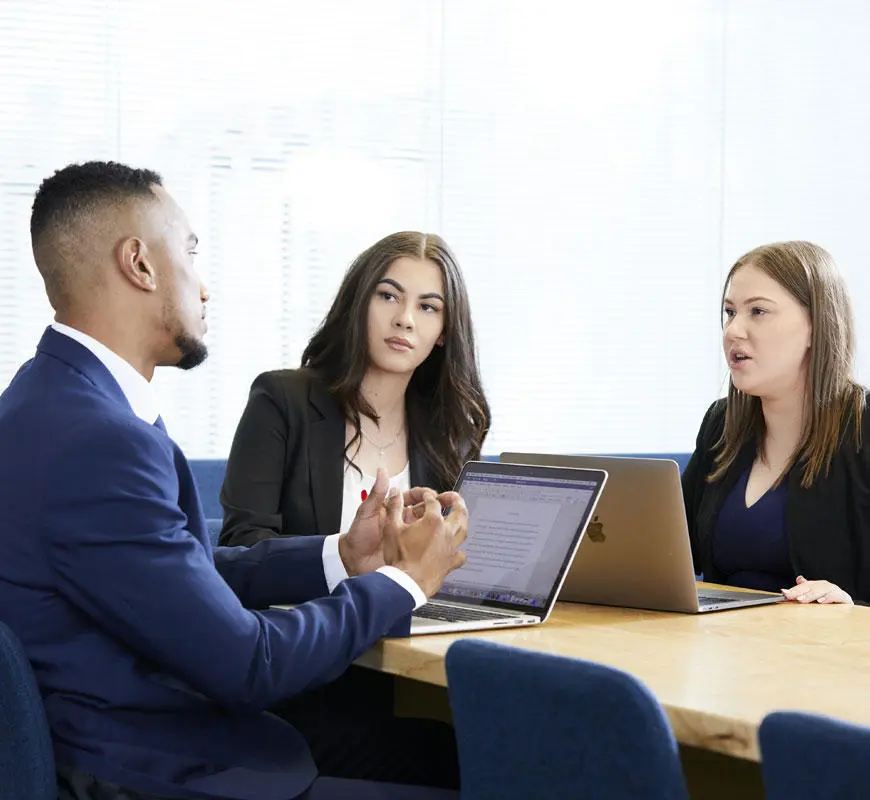 Three business students in a meeting