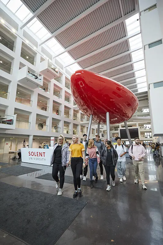 Students walking in the Spark building