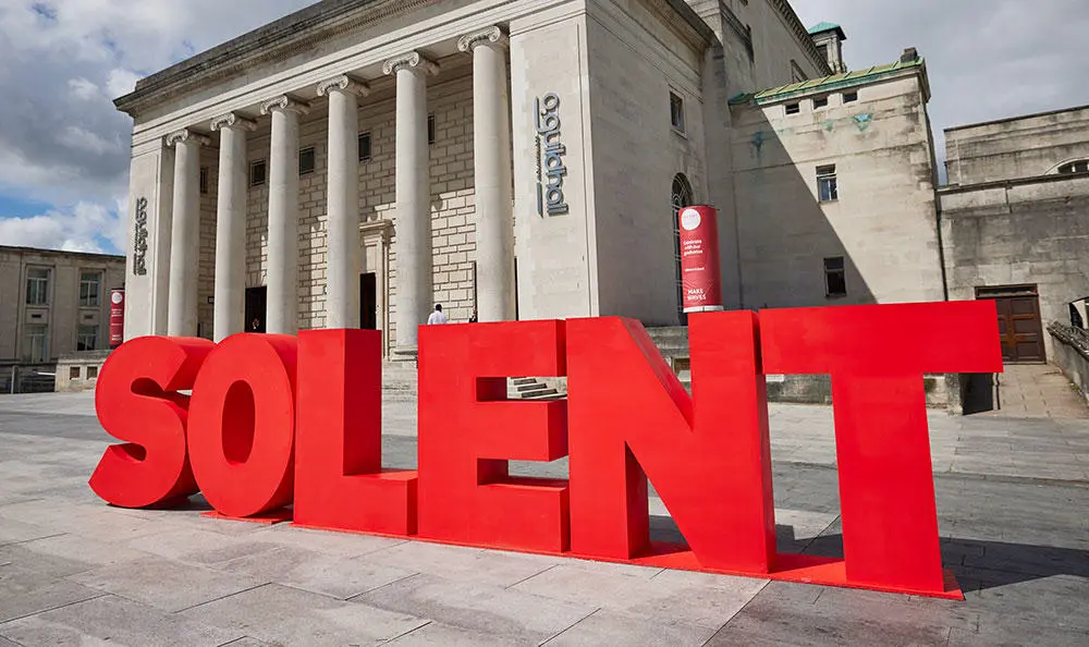 Large red letters spelling SOLENT outside Southampton Guildhall