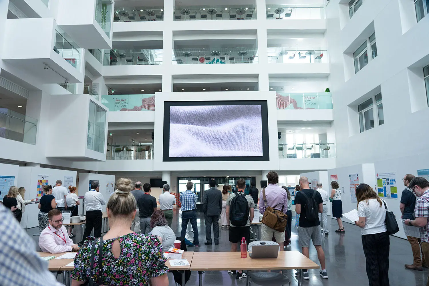 People in the Spark atrium attending the SLTR conference