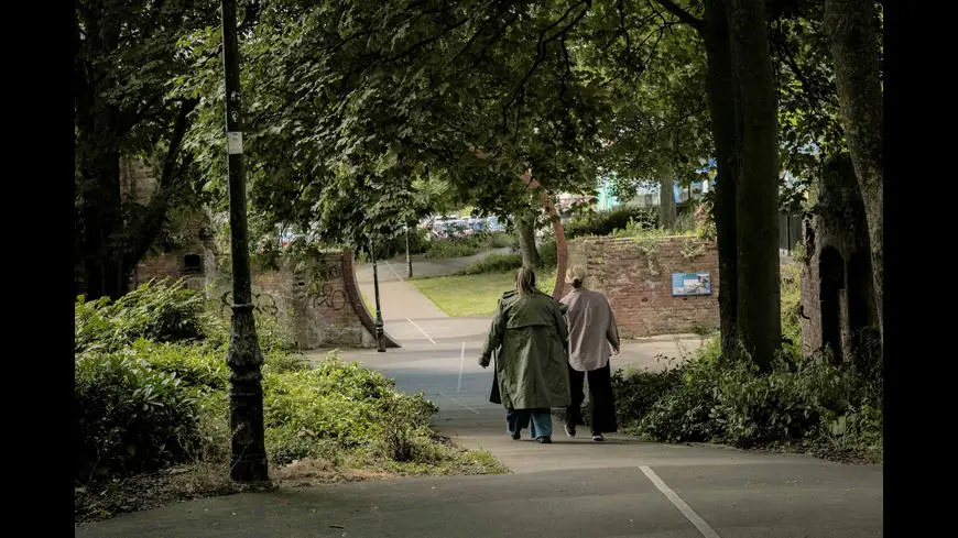 Two people walking through green spaces in Southampton