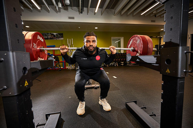 A Solent performance athlete lifting barbels