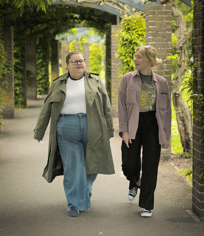 Two Solent staff members walking through one of the city's parks