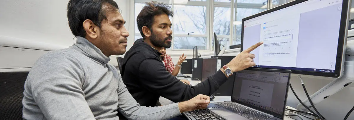 Two computing students in the lab