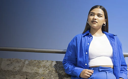 Solent student stood against a blue sky