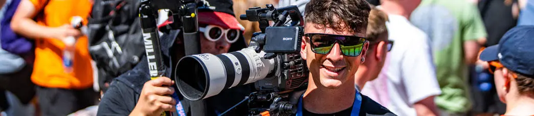 A film and TV student holding a camera at Glastonbury